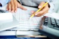 Calculator and woman holding pencil